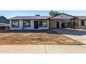 Newly renovated single story home with carport and front yard at 7213 W Osborn Rd, Phoenix, AZ 85033