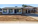 Newly renovated single story home with carport and front yard at 7213 W Osborn Rd, Phoenix, AZ 85033