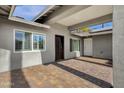 Covered entryway with brick pavers and modern door at 740 W Tuckey Ln, Phoenix, AZ 85013