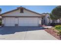 Spacious three car garage with concrete driveway and mature landscaping at 2705 E Verbena Dr, Phoenix, AZ 85048
