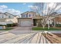 Two-story home with gray exterior, double garage, and landscaped yard at 3045 E Bloomfield Pkwy, Gilbert, AZ 85296