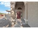 Front entrance with arched entryway, double doors, and stone pathway at 3206 E Poinsettia Dr, Phoenix, AZ 85028