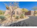 Side view of a two-story home showcasing desert landscaping and architectural details at 36601 N Mule Train Rd # B19, Carefree, AZ 85377