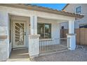 Front entrance with decorative metal door and a covered porch at 41047 N Arbor Ave, San Tan Valley, AZ 85140