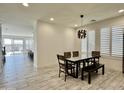 Bright dining area with a modern glass table and wood chairs at 5651 E Sierra Morena St, Mesa, AZ 85215