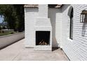 Outdoor fireplace built into the white brick exterior wall of the house at 6140 E Calle Tuberia --, Scottsdale, AZ 85251