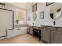 Elegant bathroom with double sinks, a soaking tub, and a walk-in shower at 6216 W Morrow Dr, Glendale, AZ 85308