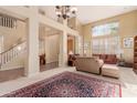 Bright living room with high ceilings and a large area rug at 6216 W Morrow Dr, Glendale, AZ 85308