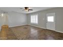 Cozy living room featuring tile flooring, and a door and window with plantation shutters at 914 N Cameron Ave, Casa Grande, AZ 85122
