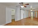 Spacious bedroom featuring parquet floors, multiple ceiling fans, and a sliding barn door at 914 N Cameron Ave, Casa Grande, AZ 85122