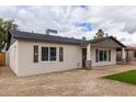 Charming single-story home featuring white siding, dark shutters, and low maintenance gravel yard at 1018 S Butte Ave, Tempe, AZ 85281