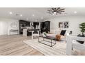 Stylish open-concept living room with sleek flooring, modern decor, and black kitchen in the background at 1018 S Butte Ave, Tempe, AZ 85281