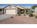 Single-story home with a two-car garage and neatly landscaped yard at 10356 W Ross Ave, Peoria, AZ 85382