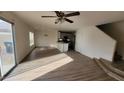 Living room with laminate floors and kitchen view at 11215 W Heatherbrae Dr, Phoenix, AZ 85037