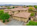 Two-story house with three car garage and desert landscape at 15296 W Coolidge St, Goodyear, AZ 85395