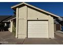 Exterior view of a light beige house with a white garage door at 1638 E Sandra Ter, Phoenix, AZ 85022