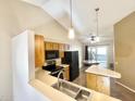 Kitchen features wood cabinets, stainless steel appliances, and a breakfast bar at 1638 E Sandra Ter, Phoenix, AZ 85022