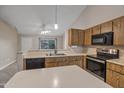 Kitchen featuring wood cabinets, a stainless steel sink, and modern appliances at 1638 E Sandra Ter, Phoenix, AZ 85022