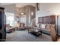 Living room with a cozy seating area, high ceilings, and a staircase at 16636 S 34Th Way, Phoenix, AZ 85048