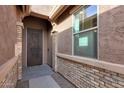 Front entry with decorative door and brick detailing at 18404 W Long Lake Rd, Goodyear, AZ 85338