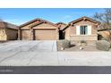 Two-story house with a three-car garage and desert landscaping at 18404 W Long Lake Rd, Goodyear, AZ 85338