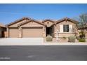 Charming single-story home with a three-car garage and desert landscaping at 18404 W Long Lake Rd, Goodyear, AZ 85338