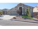 Single-story house with a two-car garage and landscaped front yard at 19778 N Coyote Lakes Pkwy, Surprise, AZ 85378