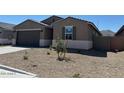 Charming single-story home features a well-maintained xeriscaped front yard with young trees in a peaceful neighborhood at 22541 W Pontiac Dr, Surprise, AZ 85387