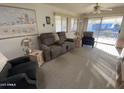 Cozy living room featuring neutral walls, plush carpeting, and comfortable seating arrangement at 2271 S Seminole Dr, Apache Junction, AZ 85119