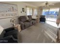 Spacious living room with recliners, access to patio, and natural light at 2271 S Seminole Dr, Apache Junction, AZ 85119