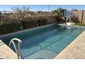 Inviting backyard pool with a basketball hoop nearby at 22917 E Camina Buena Vis, Queen Creek, AZ 85142