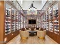 Large shoe collection room with glass cabinets and seating at 24258 N 91St St, Scottsdale, AZ 85255