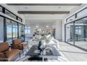 Bright living room with wood floors, beamed ceilings, large sliding glass doors and modern furnishings at 24642 N 123Rd Pl, Scottsdale, AZ 85255