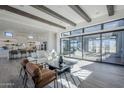 Bright living room with wood floors, beamed ceilings, large sliding glass doors and modern furnishings at 24642 N 123Rd St # 114, Scottsdale, AZ 85255