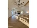 Sunlit living room, hardwood floors, fireplace, and high ceilings at 26034 S Glenburn Dr, Sun Lakes, AZ 85248