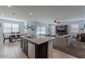 Open kitchen with granite island, dark cabinets, and stainless steel appliances at 31063 W Cheery Lynn Rd, Buckeye, AZ 85396