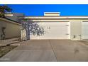 Attached garage with white door and landscaping at 3134 E Mckellips Rd # 168, Mesa, AZ 85213