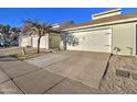 Exterior view of attached garages with driveway and landscaping at 3134 E Mckellips Rd # 168, Mesa, AZ 85213