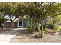 Cute bungalow with light blue exterior, gravel driveway, and desert landscaping at 3715 N 9Th Pl, Phoenix, AZ 85014