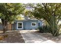 Charming bungalow with a light blue exterior, landscaped yard, and a spacious driveway at 3715 N 9Th Pl, Phoenix, AZ 85014