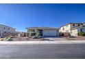 Modern house with a brick driveway and desert landscaping at 3740 S 182Nd Ln, Goodyear, AZ 85338