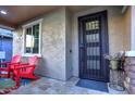 Modern front door with iron security gate and red chairs at 3894 E Ebano St, Gilbert, AZ 85295