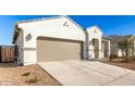 New construction home with attached two-car garage and drought-resistant landscaping at 40130 W Sunland Dr, Maricopa, AZ 85138