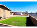 Neatly landscaped front yard with green grass and decorative plants at 4320 W Keim Dr, Glendale, AZ 85301