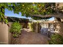 Brick pathway leads to wrought iron gate under a lemon tree at 4446 E Camelback Rd # 109, Phoenix, AZ 85018