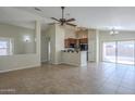 Kitchen with dark wood cabinets, black appliances, and a breakfast bar at 44865 W Horse Mesa Rd, Maricopa, AZ 85139