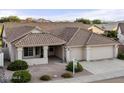 House exterior with tile roof and two-car garage at 4601 E Peak View Rd, Cave Creek, AZ 85331