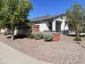 Landscaped front yard with drought-tolerant plants and gravel at 4744 W Orange Ave, Coolidge, AZ 85128