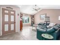 Living room with a green sectional sofa, and tile floors at 4944 E Windrose Dr, Scottsdale, AZ 85254