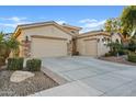 Two-car garage and attractive landscaping enhance this home's curb appeal at 5045 S Mingus Pl, Chandler, AZ 85249